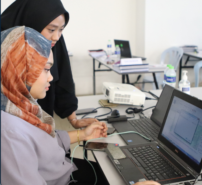 Women working on laptops in training environment
